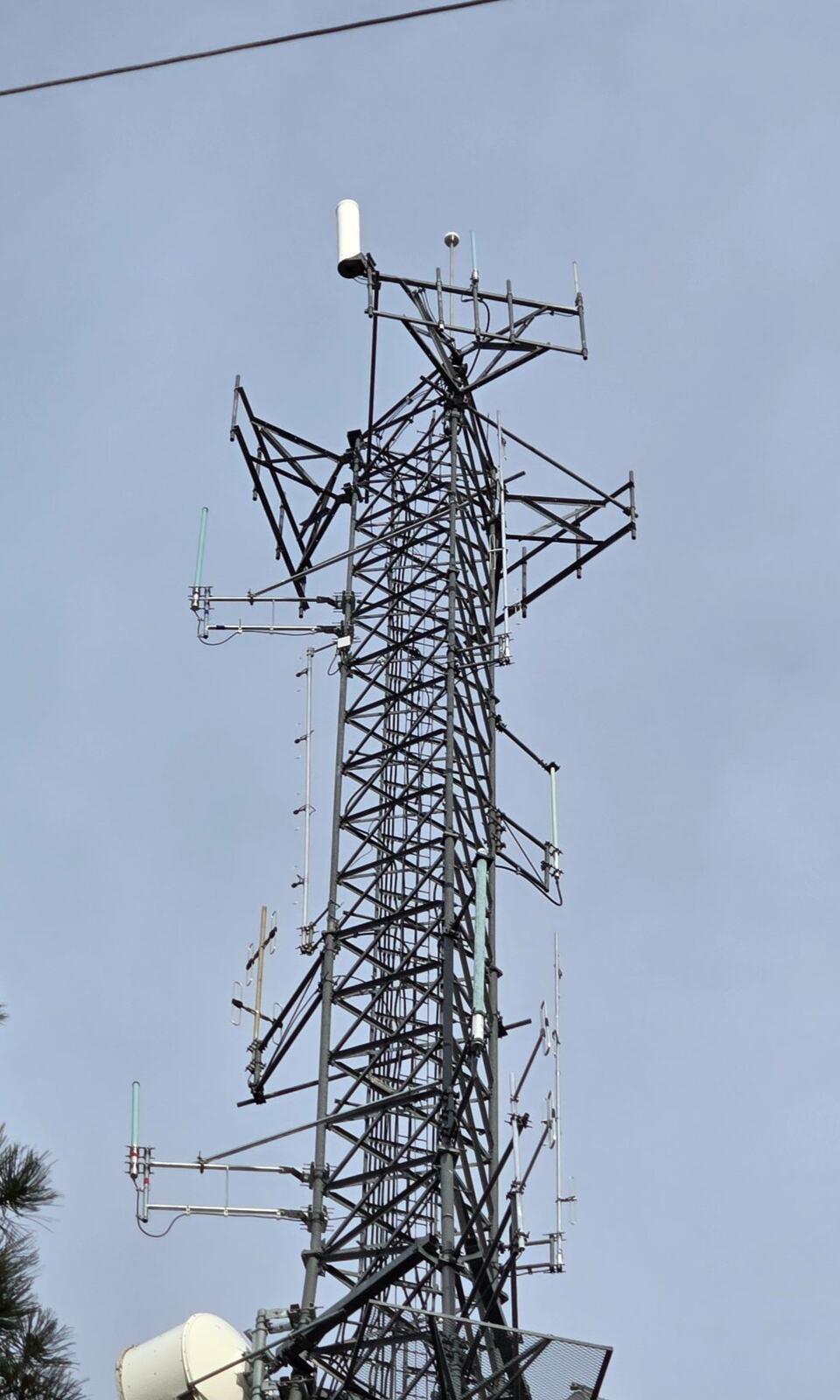 Lattice tower with public safety LMR antennas, mounts, and a microwave radome